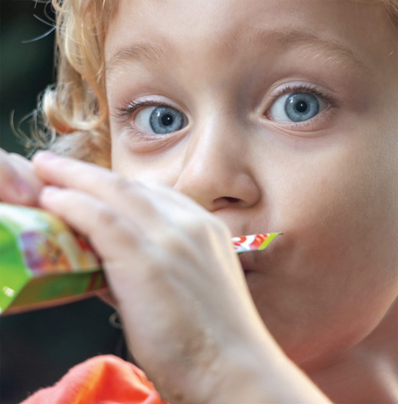 Child eating from pouch