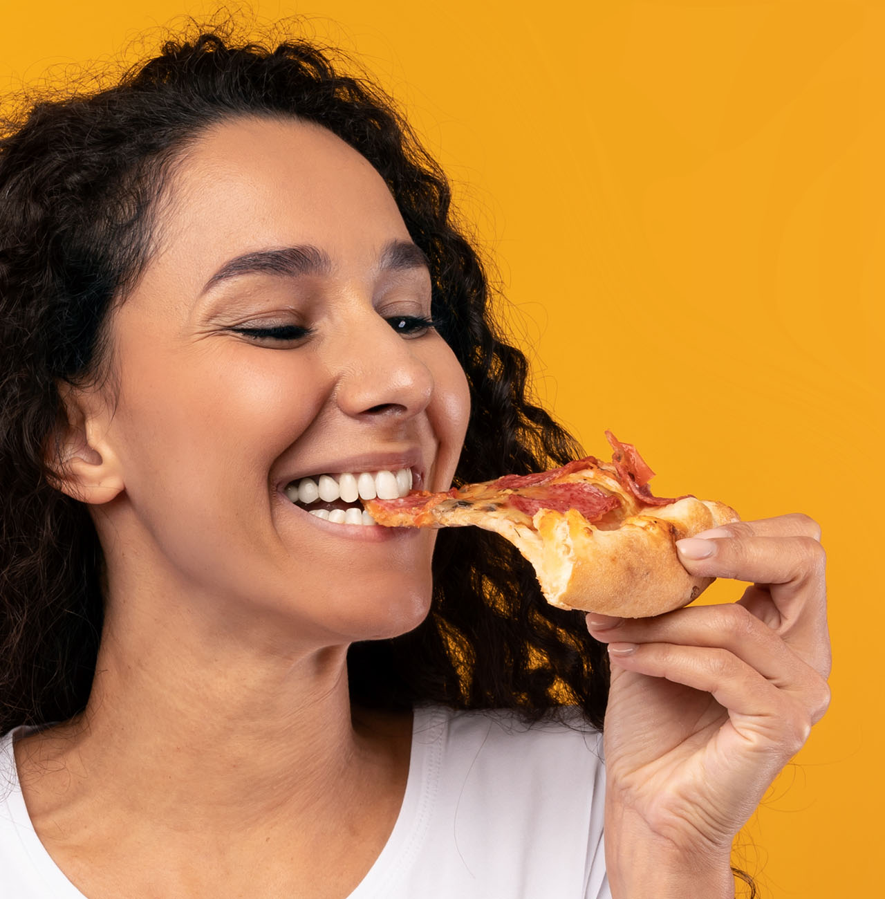 woman biting pizza