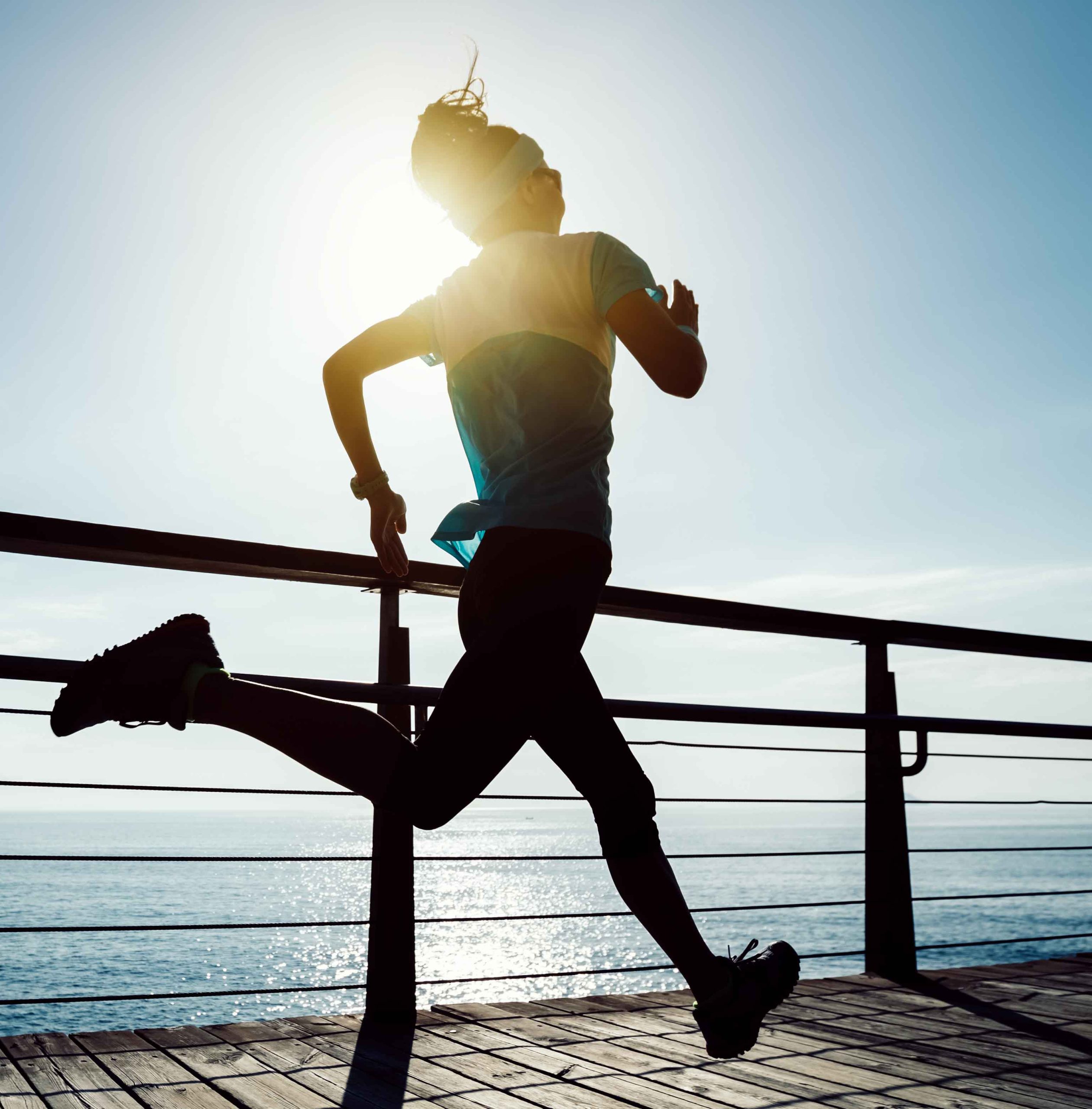 Woman running on seaside boardwalk