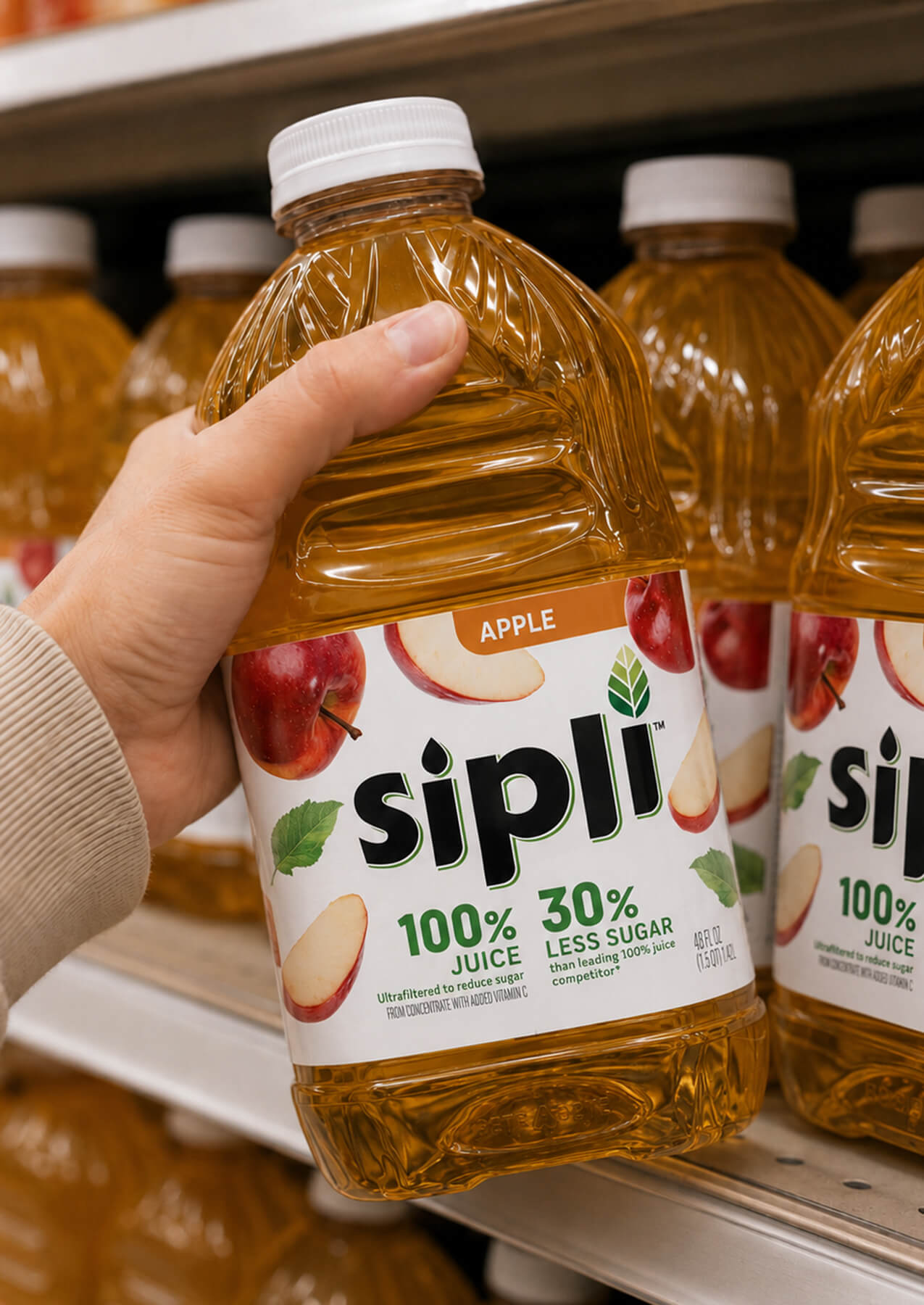 Sipli Apple Juice bottle begin pulled off supermarket shelf