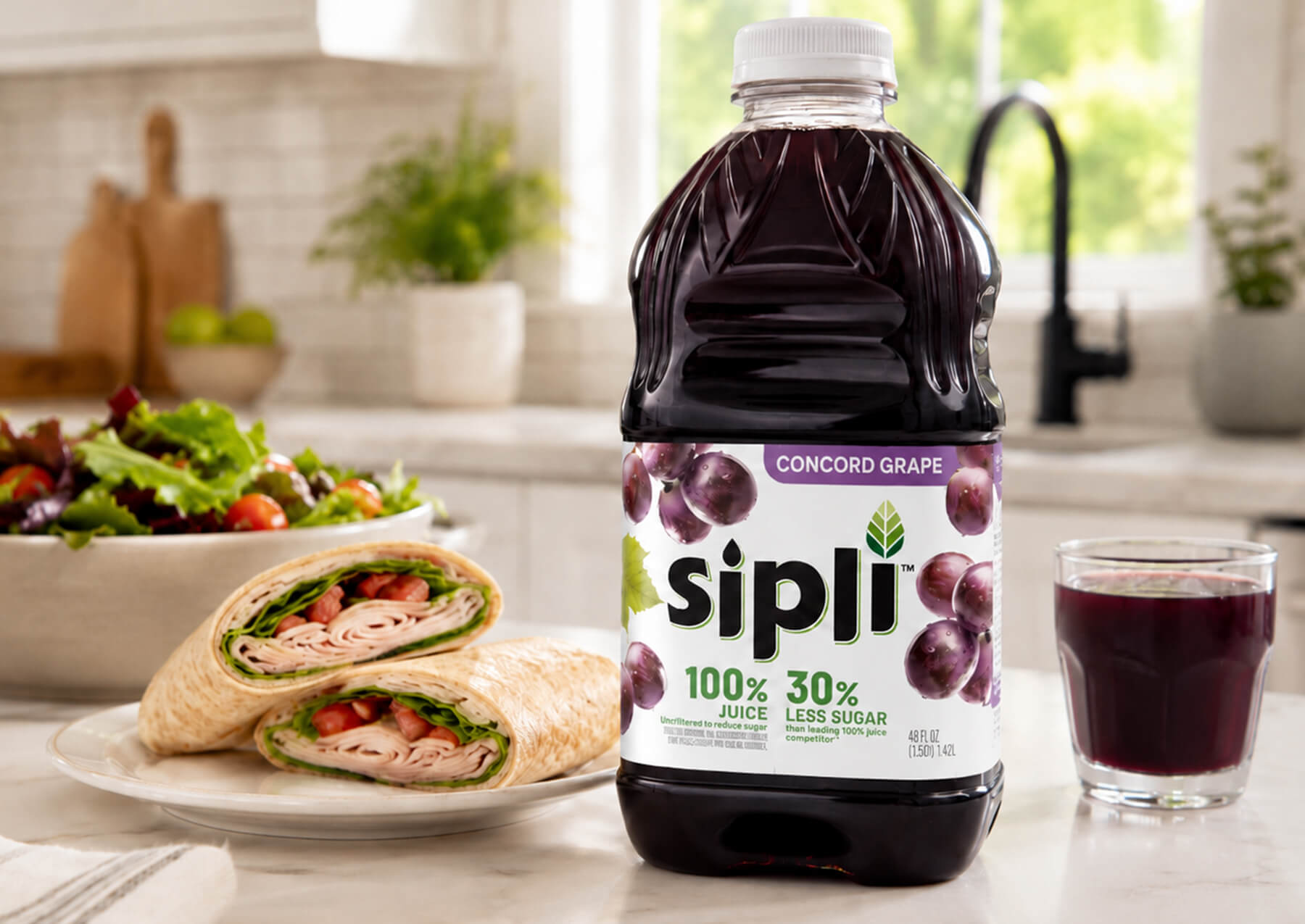 Sipli Concord Grape Juice bottle on table at lunchtime